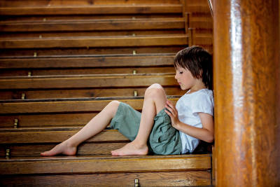 Isolated boy on stairwell