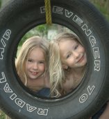 Children playing on tire swing