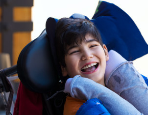 smiling child with a disability
