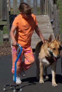 girl with cerebral palsy walking with dog